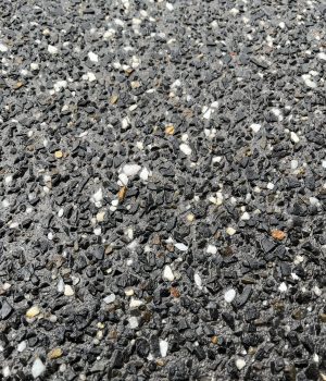 Dark exposed aggregate concrete close-up