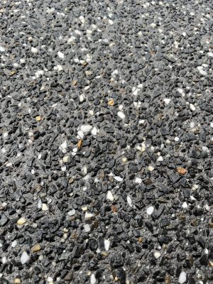Dark exposed aggregate concrete close-up